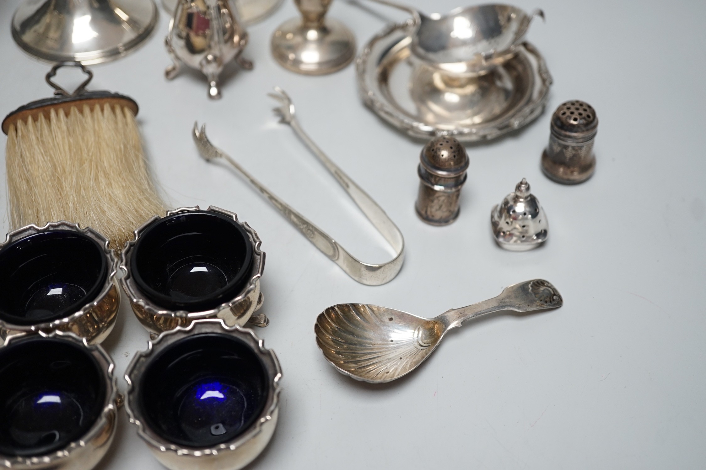 Sundry small silver including four salts by Mappin & Webb, three mounted dwarf candlesticks, two white metal Egyptian dishes and a white metal tazza, eight other items including two 19th century caddy spoons and four pla